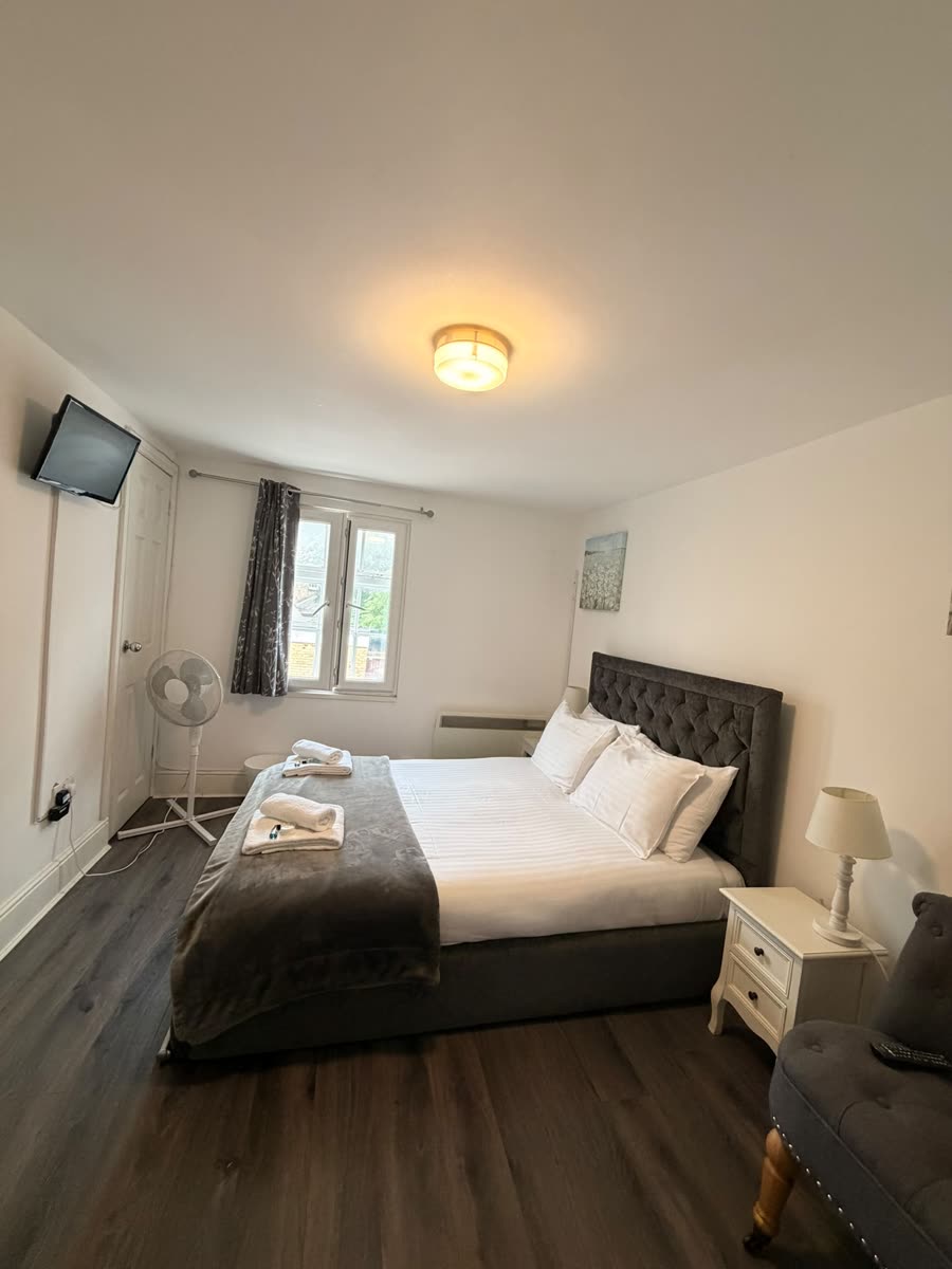 Tidy double bedroom with fresh bedding in a rented property