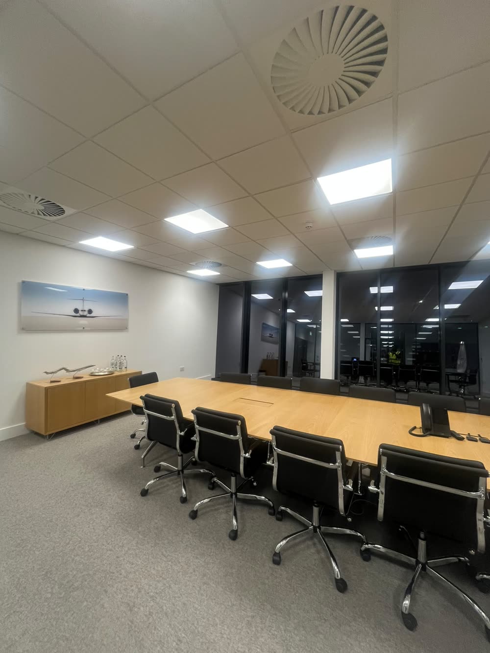 Clean boardroom with meeting table and chairs set out