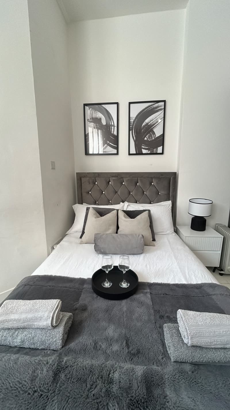 Fresh linen and folded towels laid out on a guest bed